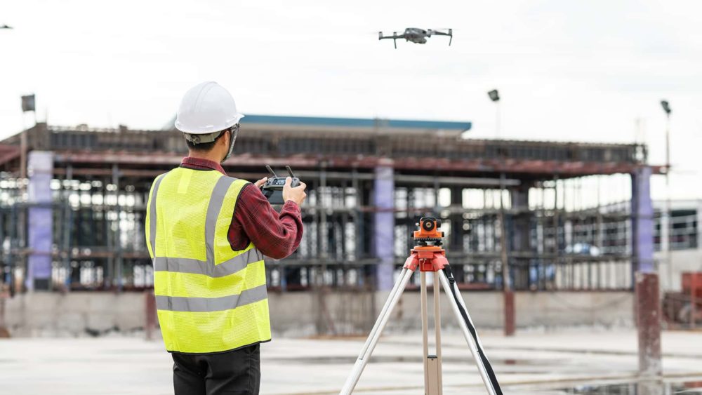construction contractor photographing job site using drone
