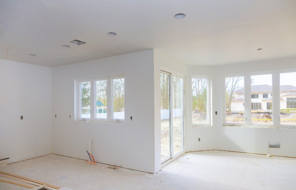 inside of residential construction project featuring windows and sliding door
