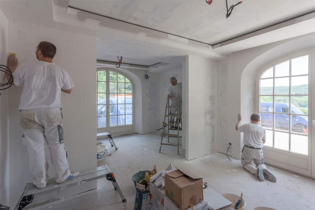 Painters painting inside a house