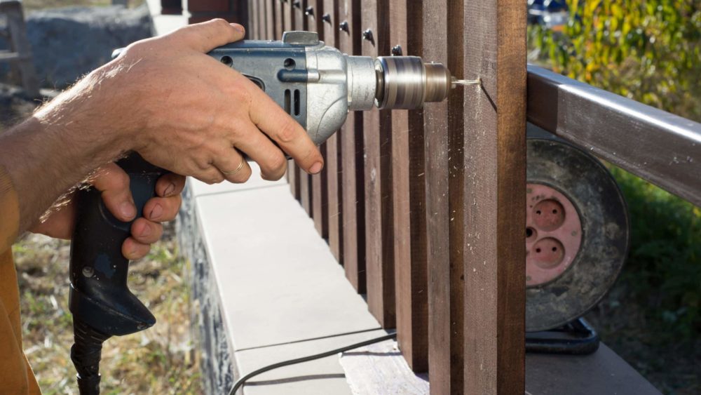 fencing contractor installing a fence