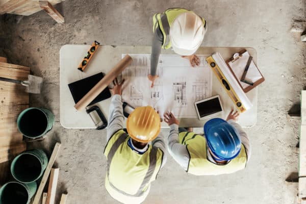 construction contractors working on blueprints