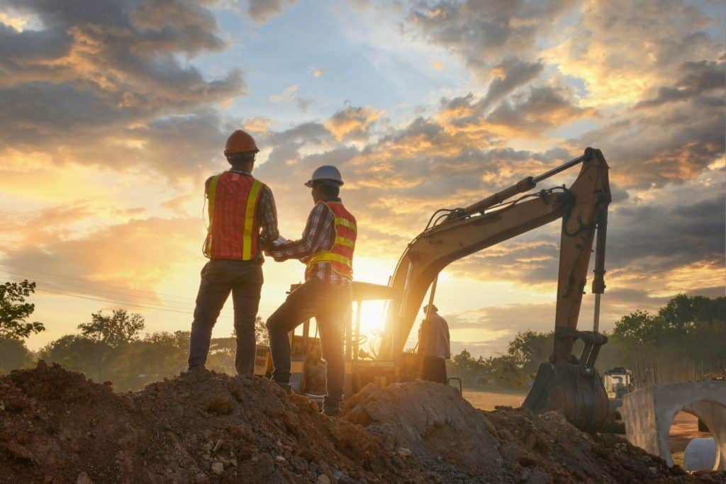 construction contractors working on site during sunrise