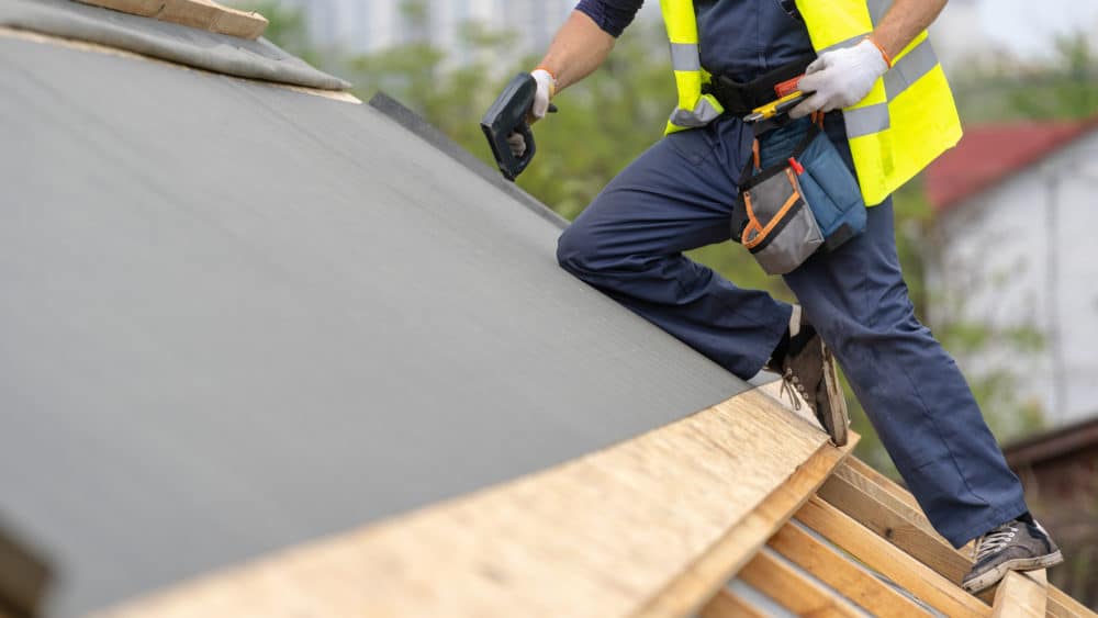 Roofing contractor on roof