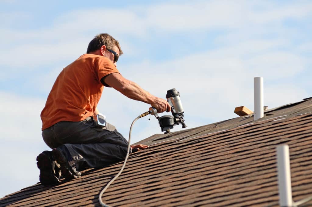 roofing contractor using a nail gun