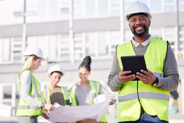 smiling contractor calculating overhead costs