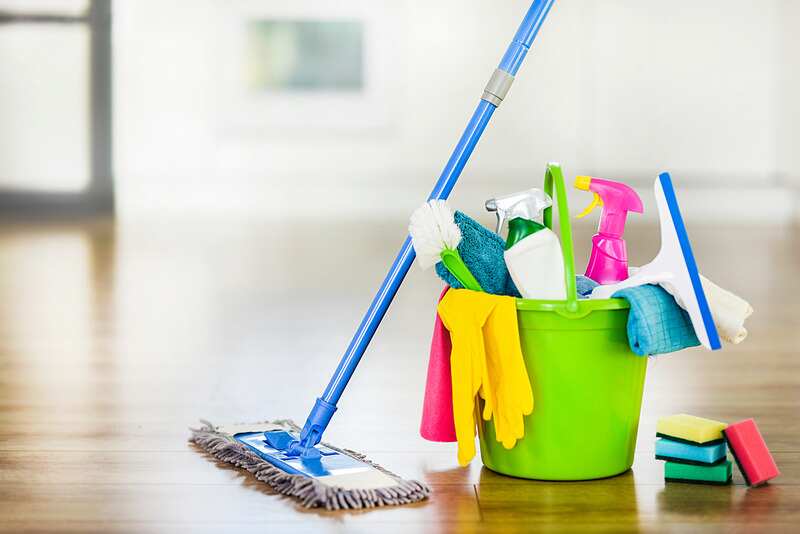 Bucket with cleaning items washing brush and spray set with copy space