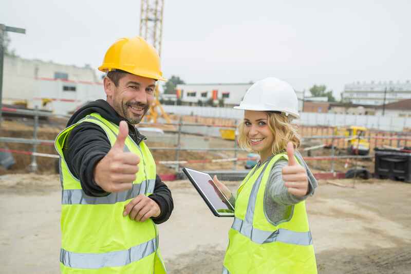 Construction workers thumbs up and smiling