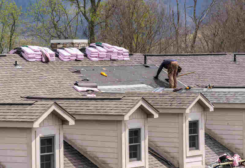 Roofing contractor removing the old tiles