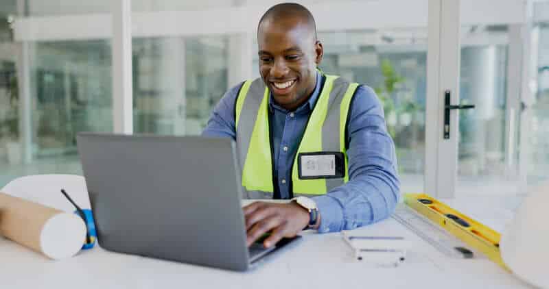 Computer, design and a happy young construction worker