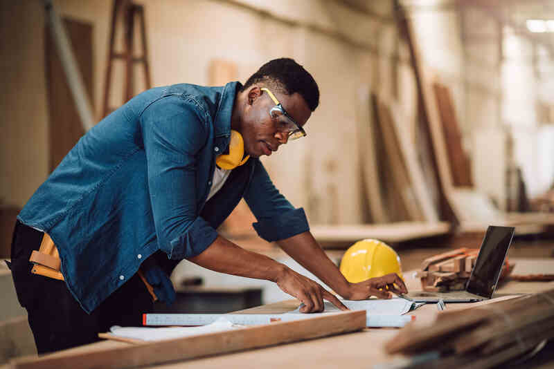 carpenter craftman working in wood factory, small business wood workshop