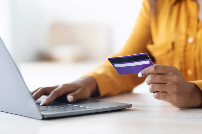woman using computer and credit card