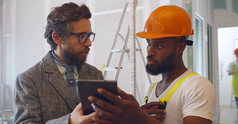 Contractors and client review tablet together