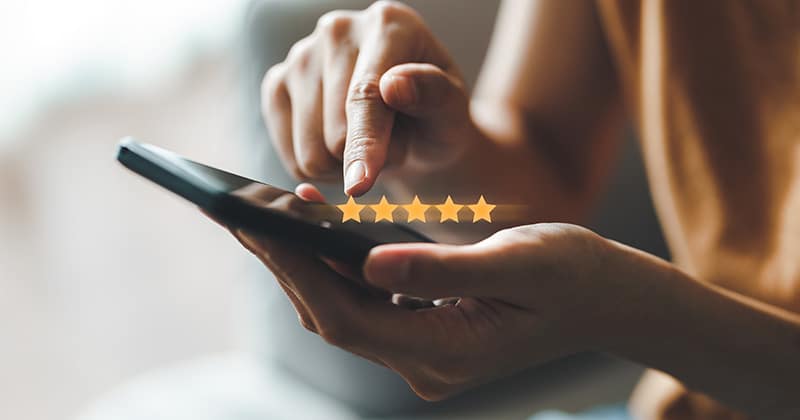Client using phone to leave 5 star review