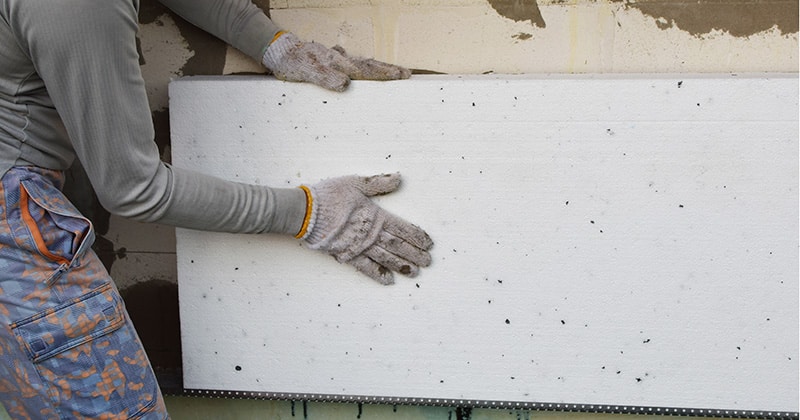 Home renovation expert installing rigid styrofoam insulation board
