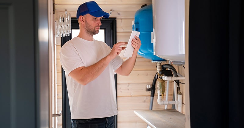 Tech using tablet to send receipt on jobsite