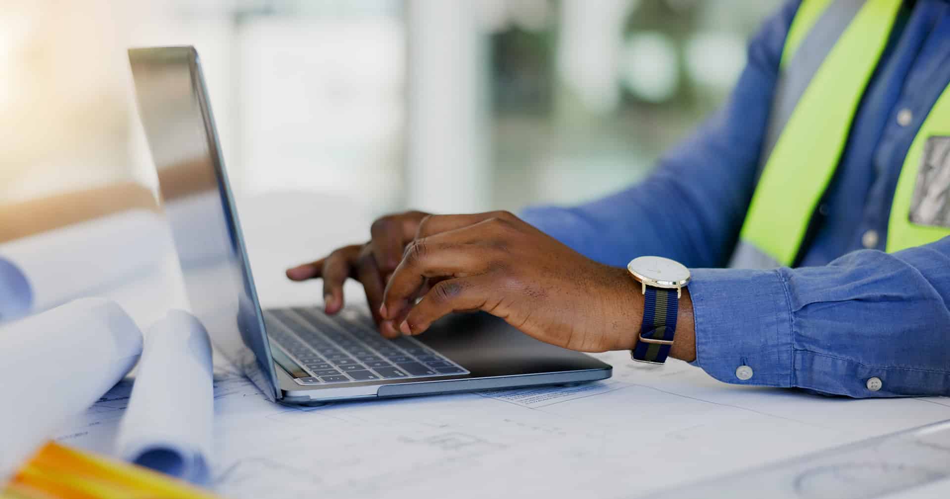 Close up of contractor working on laptop