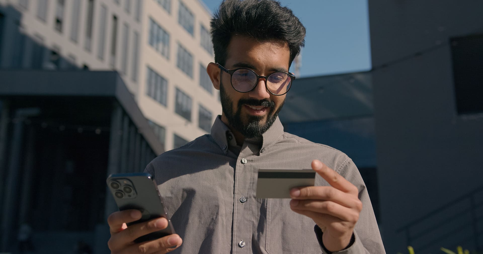 Contractor holds credit card and phone to take payment