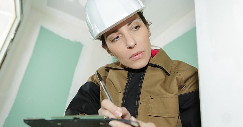 Construction estimator doing survey in home