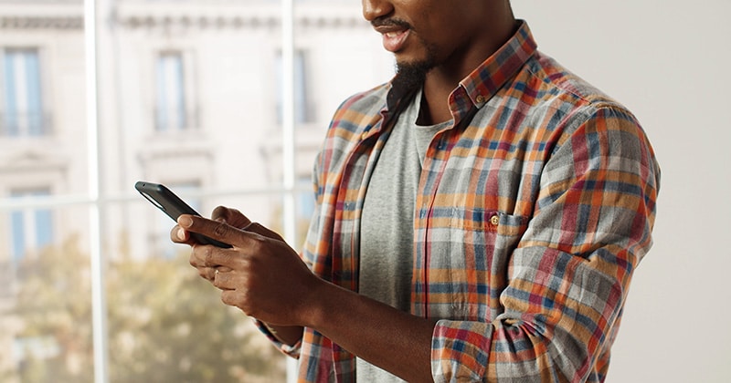 Contractor checking digital marketing efforts on smartphone