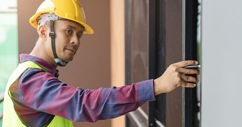 Contractor inspecting building