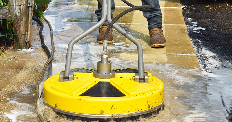 Pressure washing on concrete pathway