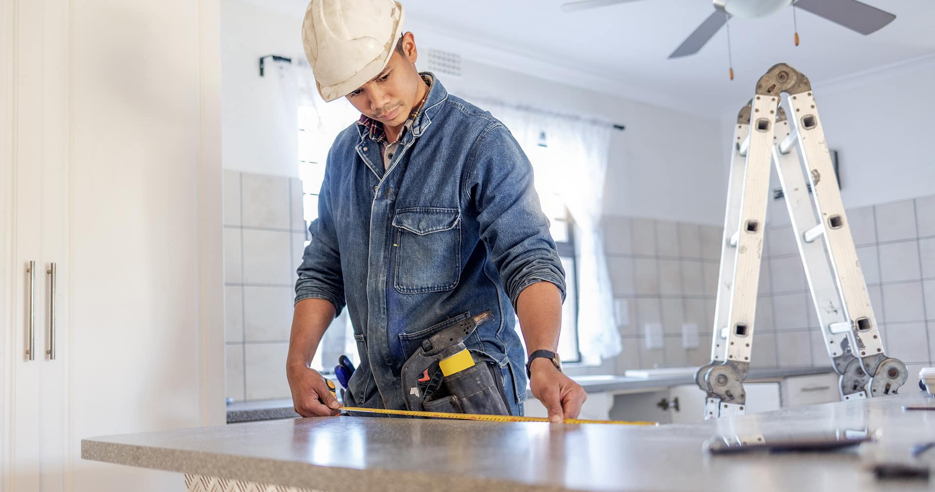 Contractor taking measurements for kitchen renovation