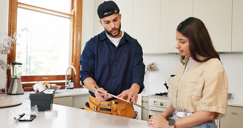 Plumbing contractor discusses repair and terms with client