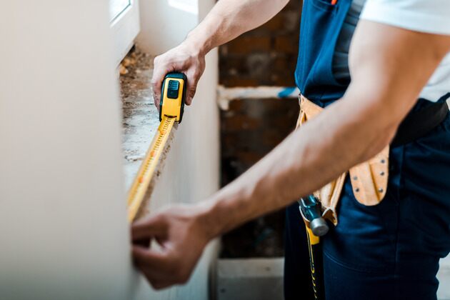 Handyman with a mesuring tape