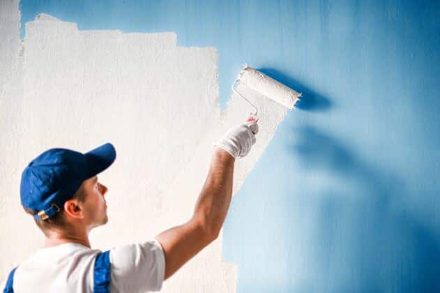 Painter painting a wall
