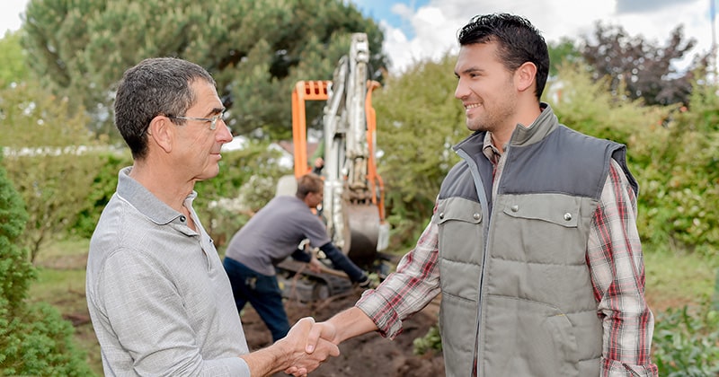 Client and contractor shaking hands outdoors