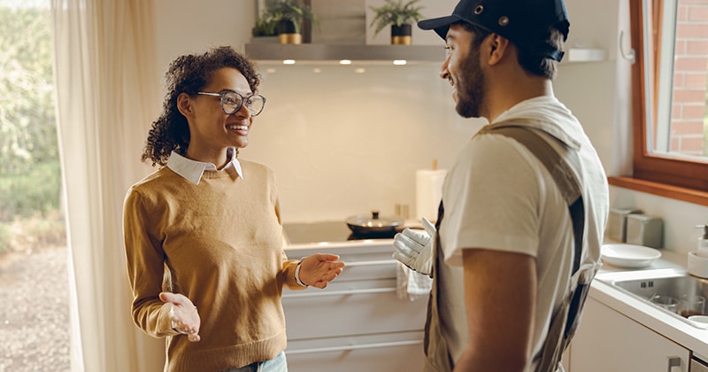 Client and contractor talk in kitchen