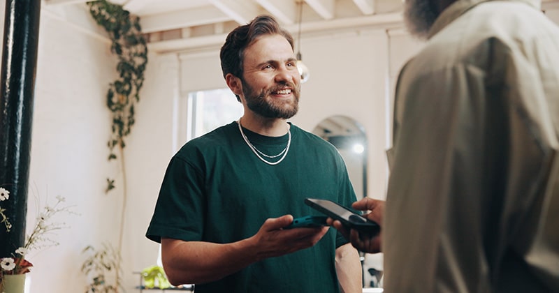 Contractor accepting tap to pay payment from phone