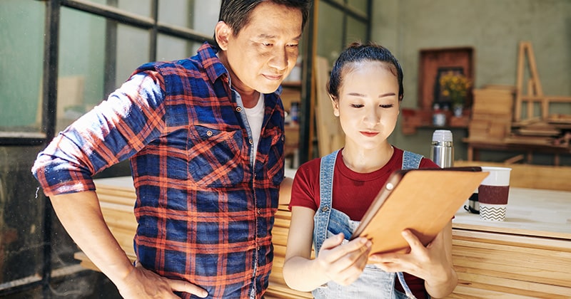 Contractor and client review tablet together