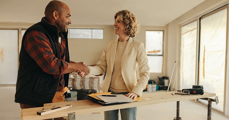 Contractor and home owner shake hands in agreement for home renovation