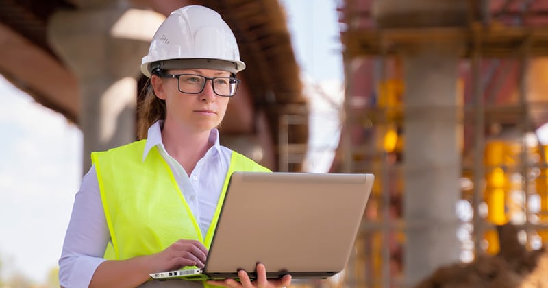 Foreman with laptop at construction site