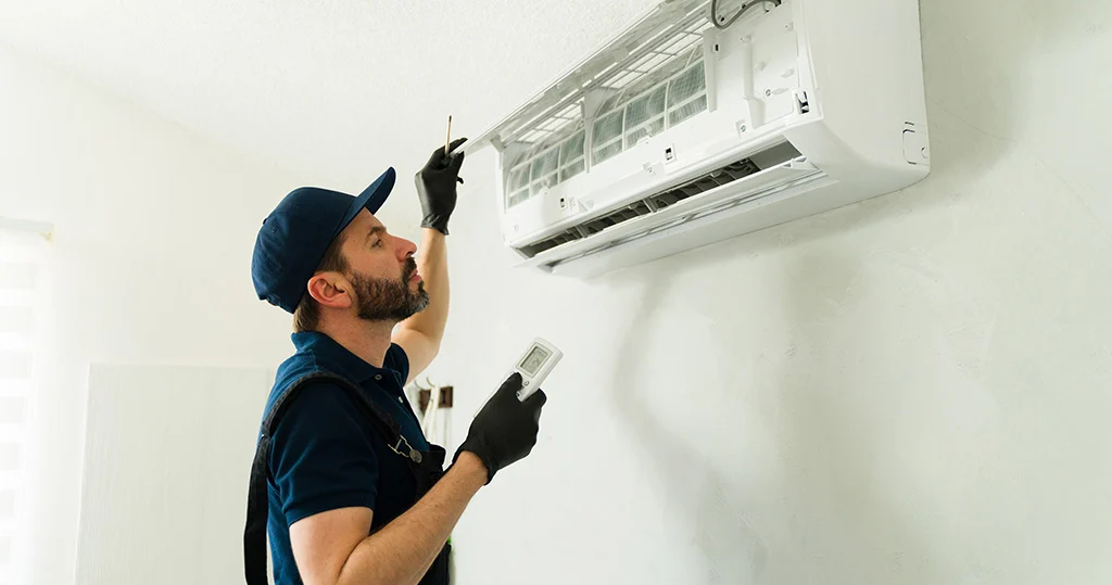 HVAC tech repairing air conditioning unit