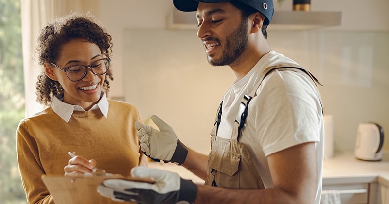 Handyman and client review paperwork together