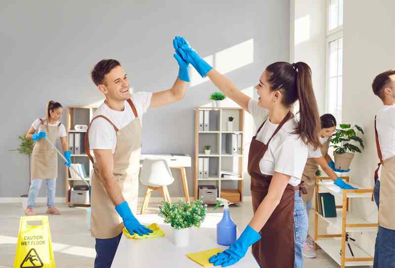 Happy cleaners group high five