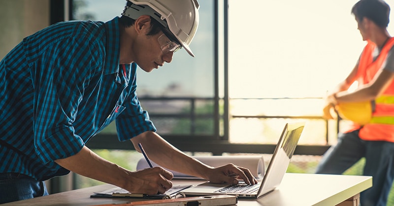 Home pro on laptop at home construction site