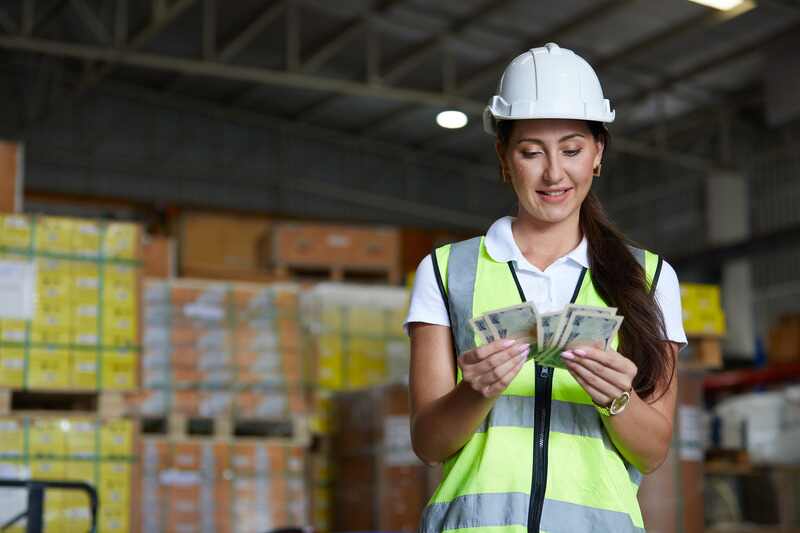 worker counting money in the warehouse storage